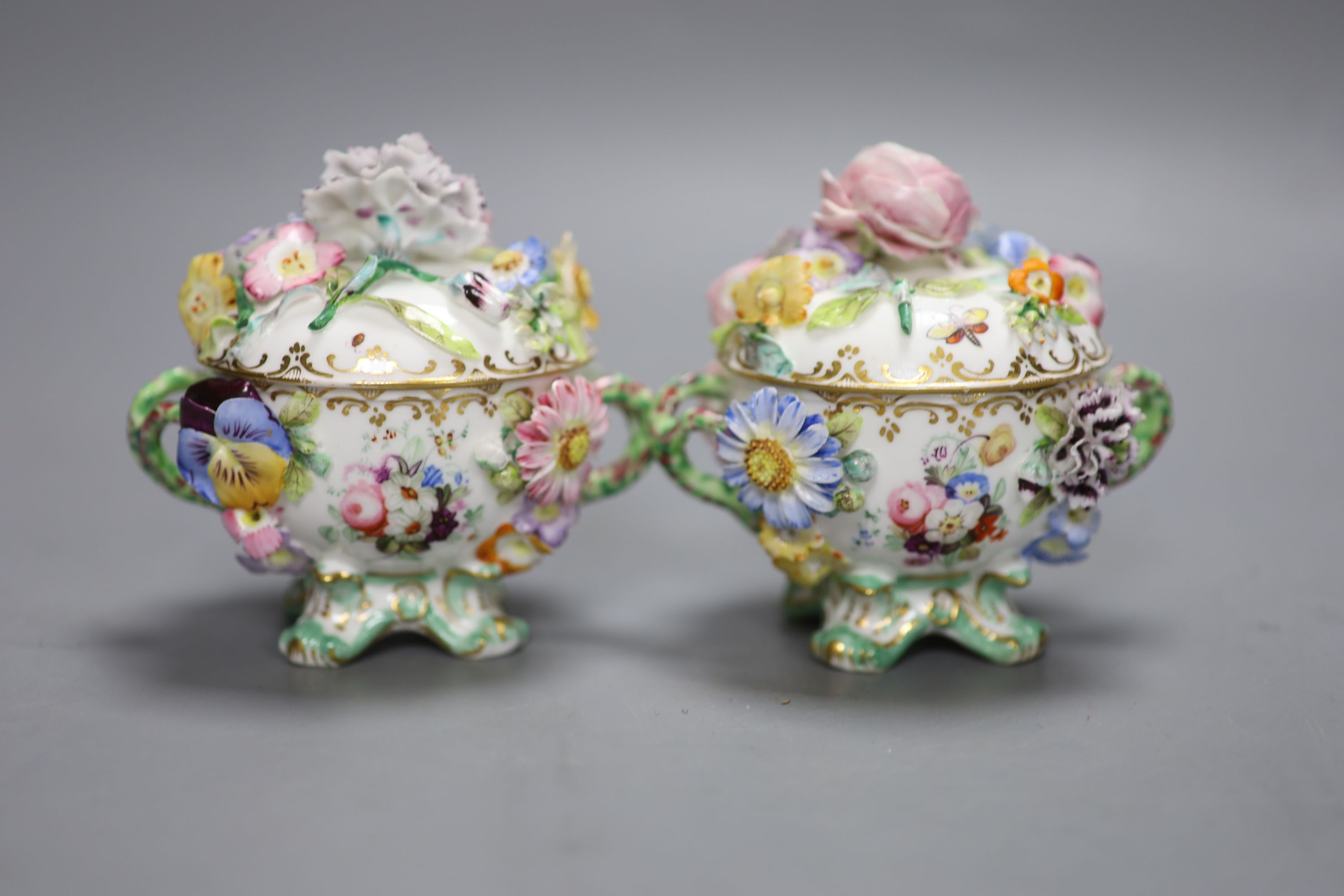 A mid 19th century Coalport pair of floral encrusted two handled cups and covers